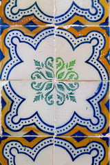 Azulejos, colorful painted ceramic tiles on a house front in Tavira, Algarve, Portugal.