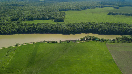 Aerial landscape nature - Dense green forest, green meadows, lake in southern Russia