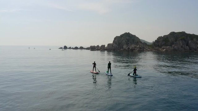 SUP surfers in the sea bay, beautiful islands in the Sea of ​​Japan, Russia
