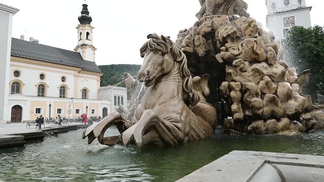 Fountain with lions in the center square in Austrian Salzburg filmed in slow motion.