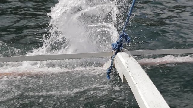 Water splash coming from Philippines boat with tourists, filmed in slow motion