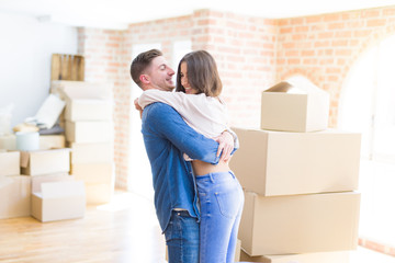 Fototapeta na wymiar Beautiful young couple hugging in love, very happy moving to a new house