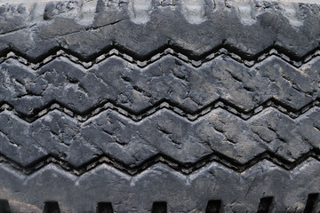 close up old damaged and worn black tire tread truck. Tire tread problems and solutions for road safety concept. Change time. transportation. Write text in the texture background and backdrop.