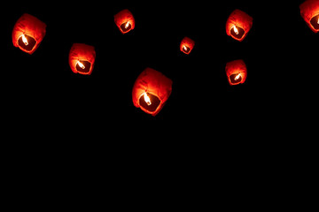 Flying Paper Sky Lantern On Diwali. Sky lanterns isolated on Black background with copy space....