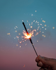 Man's Hand Holding Sparkler. Happy Diwali or New Year or Birthday sparkler celebration. Background...