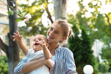 Fototapeta premium Teen nanny with cute baby in park on sunny day