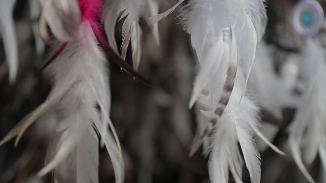 Wind move feathers and fluff in souvenir shop, filmed in slow motion in Philippines El Nido.