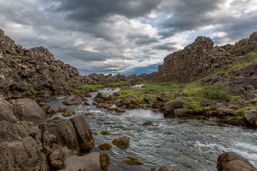 Fototapeta na wymiar Mountain river flows between stone ridges