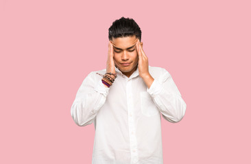 Young man with headache on colorful background