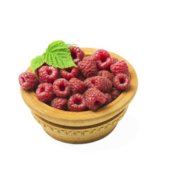 wooden bowl full of freshly picked raspberries on white table.