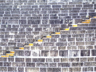 Yellow steps leading to the top in a concrete staircase.
