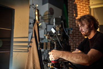 Behind the scenes of filming films or video products and the film crew of the film crew on the set in the pavilion of the film studio.