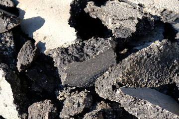  Old road surface. Pieces of asphalt