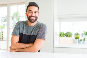 Fototapeta premium Handsome hispanic man wearing casual t-shirt at home happy face smiling with crossed arms looking at the camera. Positive person.