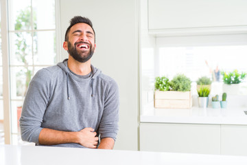 Handsome man smiling cheerful with a big smile on face showing teeth, positive and happy expression