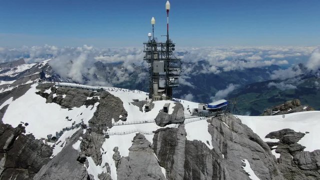 Drone view to antenna and cable car on the top of Titlis mountain in Switzerland.