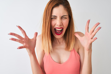 Beautiful redhead woman wearing casual pink t-shirt standing over isolated white background very happy and excited, winner expression celebrating victory screaming with big smile and raised hands