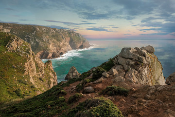 Seascape, rocky coast of the Atlantic Ocean, near Cape Roca in Portugal in spring at sunset