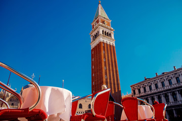 Summer terrace, European cafe on street, Piazza San Marco in background
