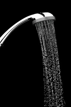 Water Drops Flowing From Shower Head In Bathroom On Black Background ,stop Motion