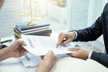 Businessman and lawyer talked about the contract. Legal concept and contract.