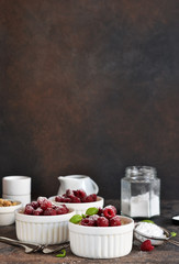 Cheesecake - The classic dessert cheese cream with raspberries. Dessert on the kitchen table. Souffle with cream and berries.