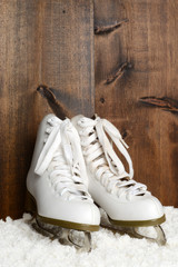 women ice skates with wood wall
