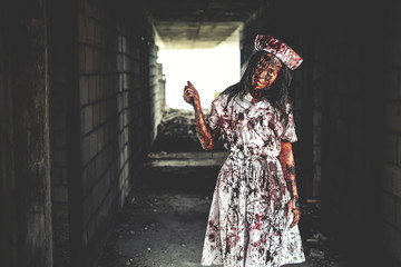Horror of ghost nurse woman or zombie held the knife. In of the abandoned hospital.