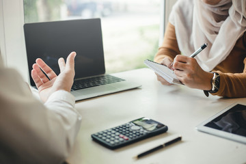 Hand of the businessman who is presenting information and analyzing the market.