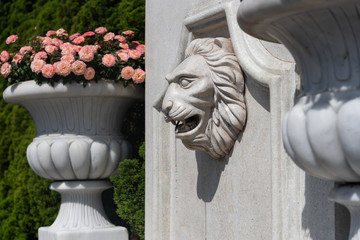 Lion head fountain made from stone decoration in garden.