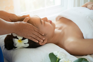 Obraz na płótnie Canvas Beautiful young woman having head massage in spa salon. Relax healthcare concept.
