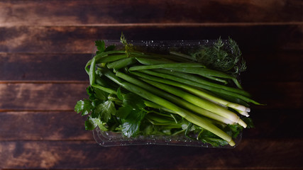 fresh herbs, onions, parsley, dill on the table