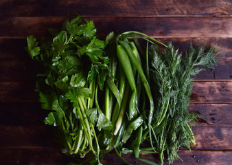 fresh herbs, onions, parsley, dill on the table