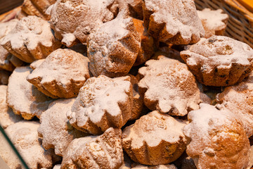 lots of chocolate cake muffins cupcakes close up with powdered sugar