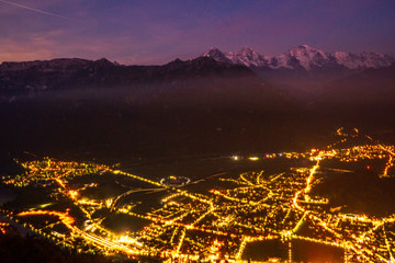 view from Harder Kulm down on Interlaken at night. bright lights in the city surounded by the two lakes Thunersee und Brienzersee