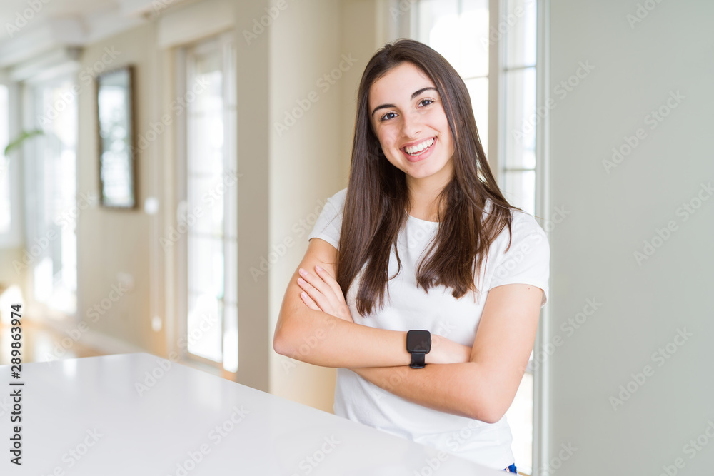 Sticker Beautiful young woman wearing casual white t-shirt happy face smiling with crossed arms looking at the camera. Positive person.