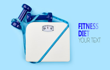 bathroom scales and measuring tape for weight loss concept on blue background. Sport and diet for...