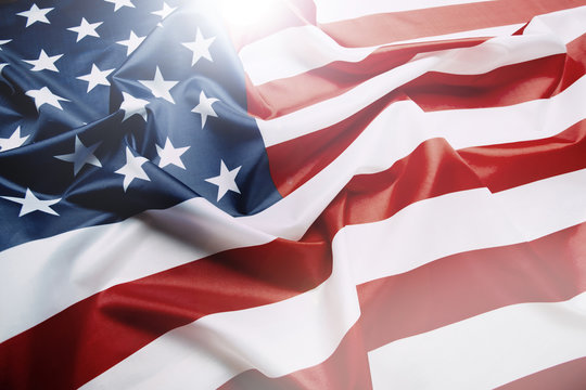 Flag of the United States of America closeup. Symbol of freedom and democracy. Independence day. American flag waving in the wind.