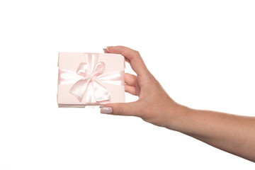 Hands holding a beautiful gift box, woman gives a gift, isolated on white background