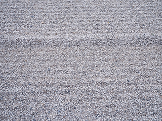 Small pebble stone ripple pattern used for flooring Japanese garden.