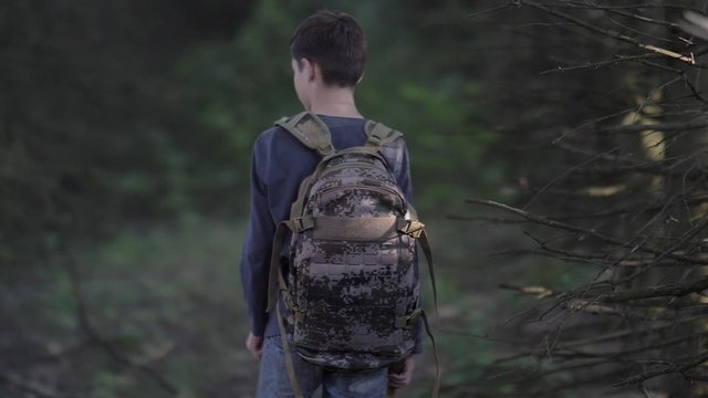 Frightened Boy Walks Through A Terrible Dry Forest In The Evening Looks Around slow motion