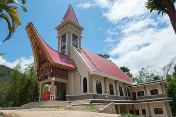 Traditional Alang rice barn and church , Rantepao, Tana Toraja, South Sulawesi, Indonesia . Alang  houses  have a distinguishing boat-shaped.