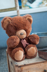 Closeup of vintage teddy bear plush sitting at the flea market