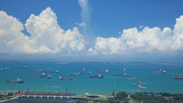 Time Lapse shot of hundreds of cargo ships anchored off the coast of Singapore.