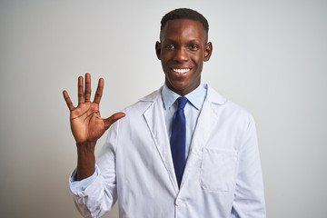 Young african american doctor man wearing coat standing over isolated white background showing and...
