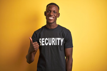 African american safeguard man wearing security uniform over isolated yellow background doing happy...
