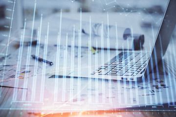 Forex Chart hologram on table with computer background. Multi exposure. Concept of financial markets.