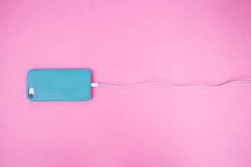 Smartphone in a mint case on a pink background.