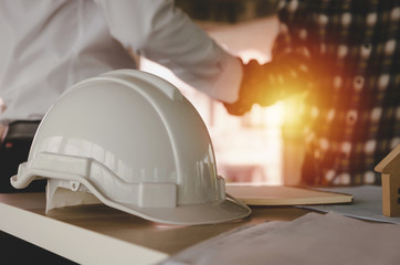 construction worker team hands shaking greeting start up plan new project contract behind white...