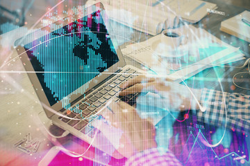 Multi exposure of businessman working on laptop on background. International business hologram in front. Concept of success.